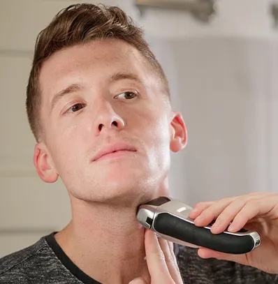 A person with a shaving head shaver on a cleaning mode from the owner's manual 