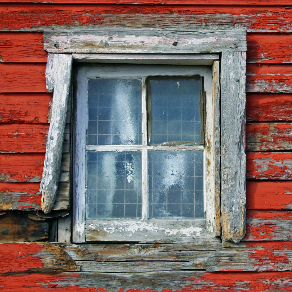 An image showing a window that needs replacement because it is damaged.