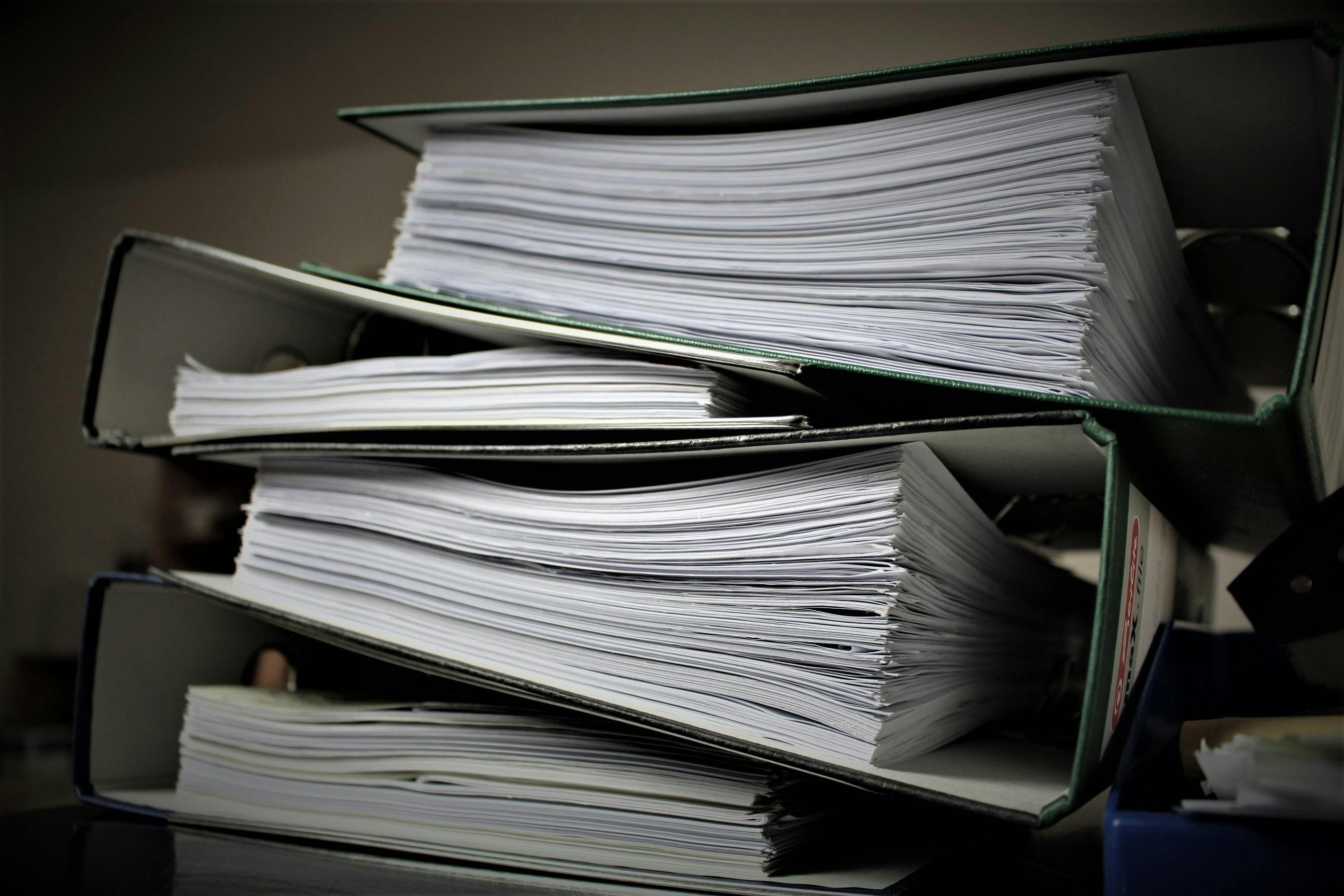 Stack of documents collected by real estate investor. 