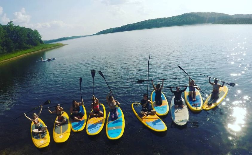 a group on yoga paddle boards