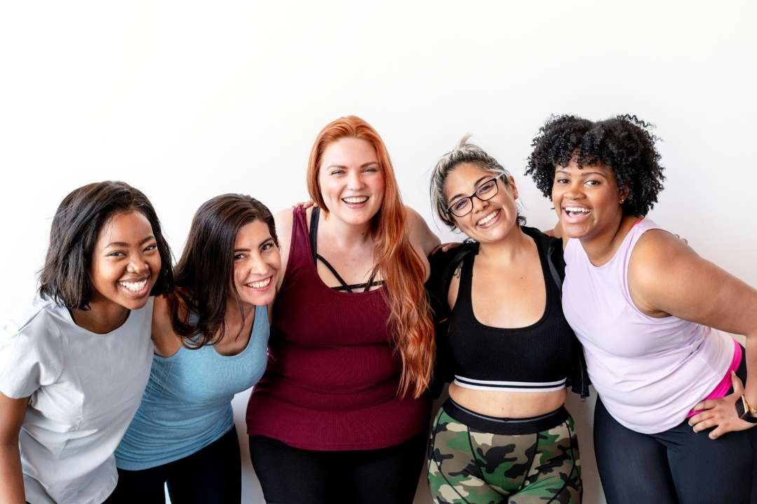 Smiling women embracing wellness in 'Top 10 Supplements To Boost Immune System Now', showing how maintaining a healthy diet, taking vitamin D, and including citrus fruits can improve overall health and immune health, reducing the risk of viral infections and boosting white blood cell production.