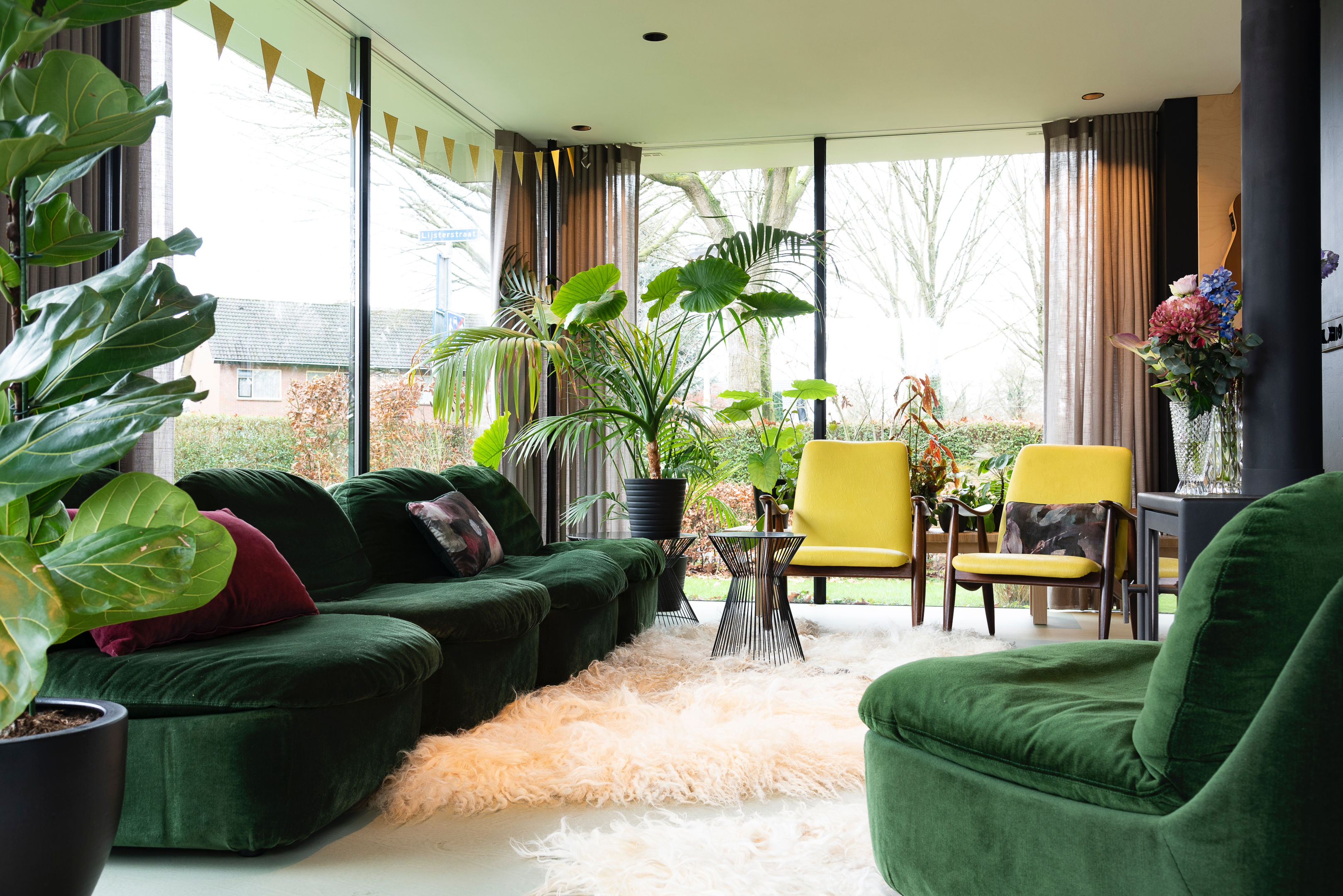 green velvet couches large plants living room