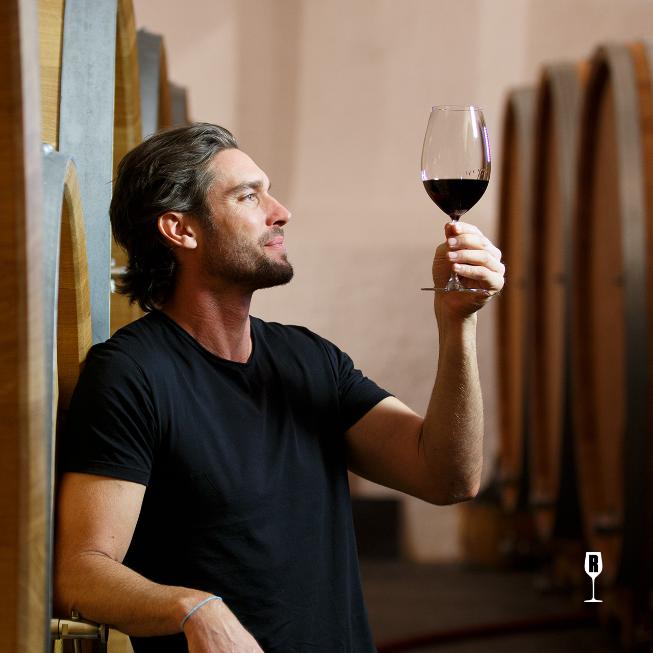 Man checking the color of a red wine