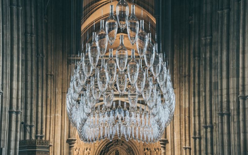 A glass chandelier hanging from a ceiling