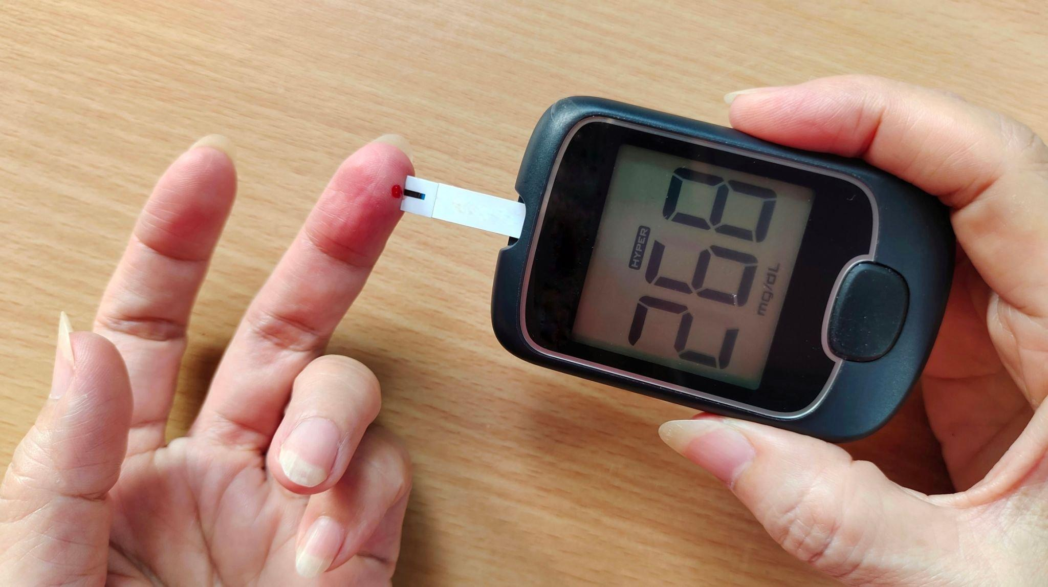 An individual performing a blood sugar test through fingerpricking, a common method to check for stress hyperglycemia.