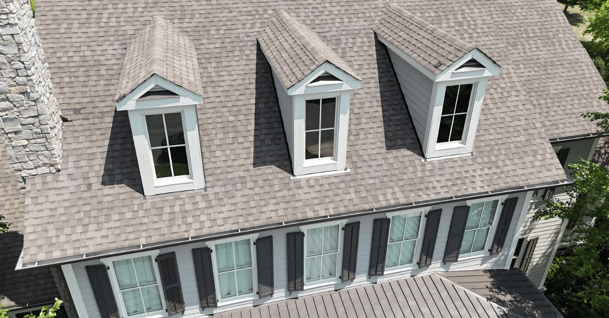 Front view of dormers on a steep-sloped asphalt shingle roof, enhancing attic space and ventilation.