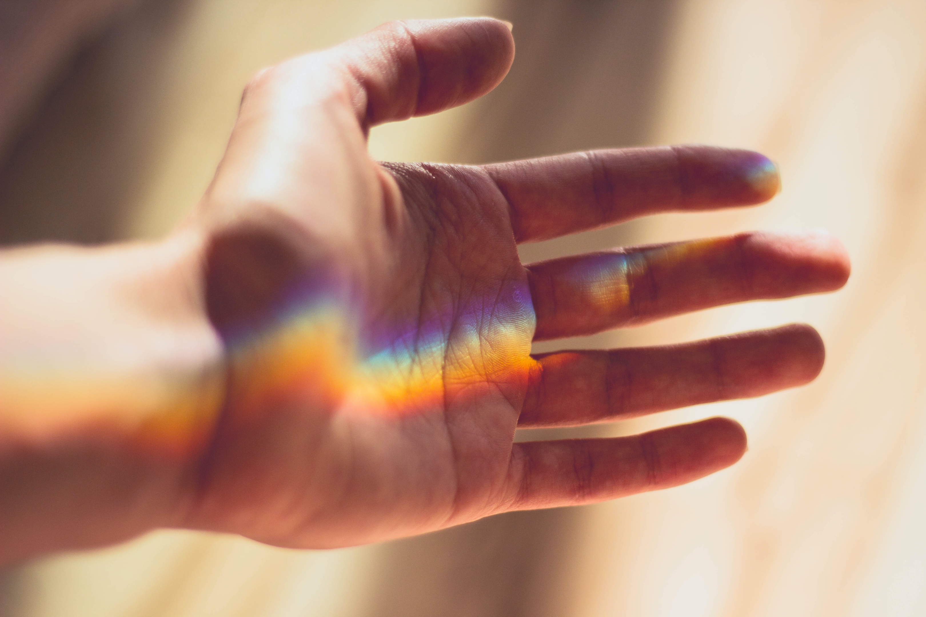 hand with rainbow shining in it 