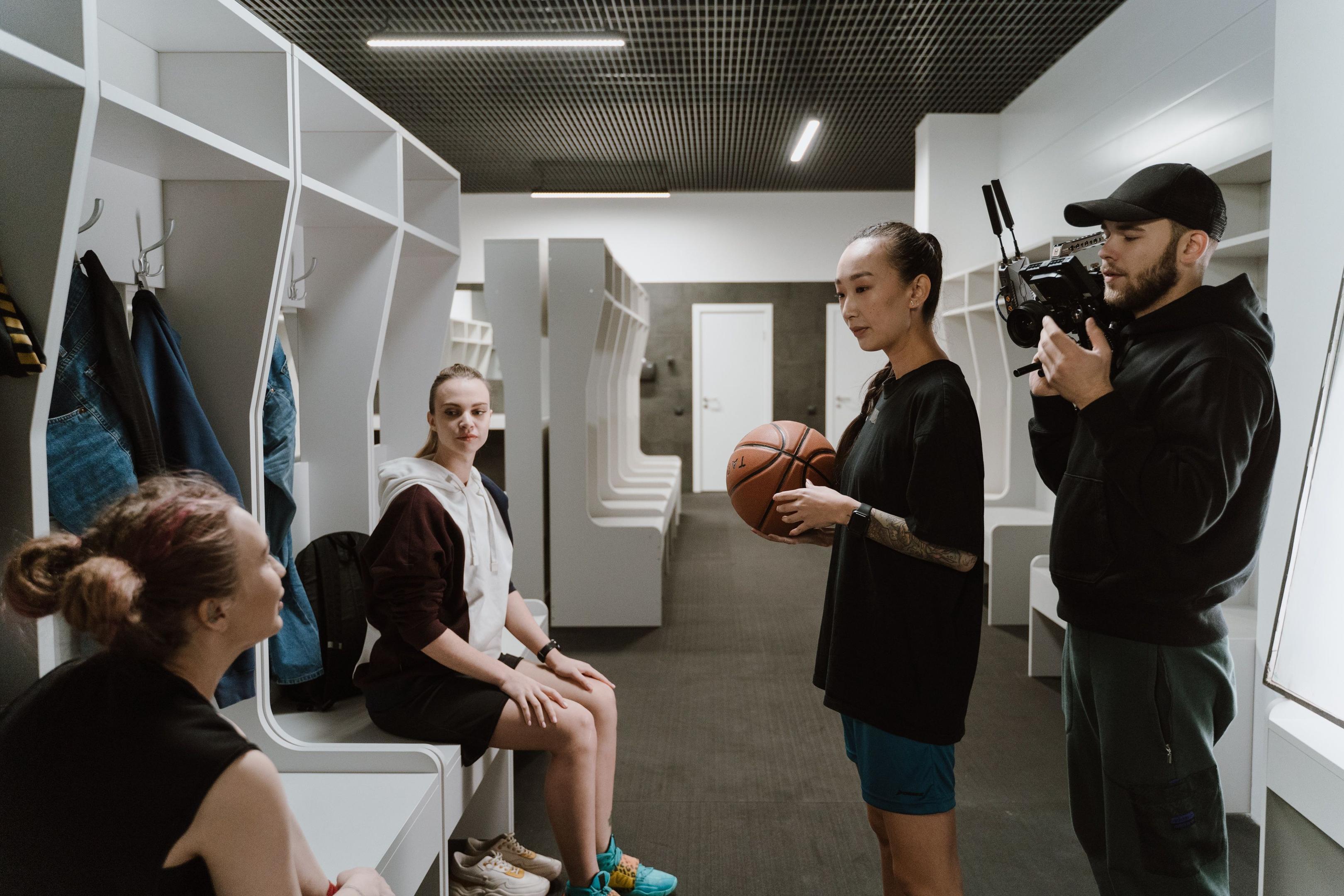 A women's basketball player is being interviewed by a media outlet