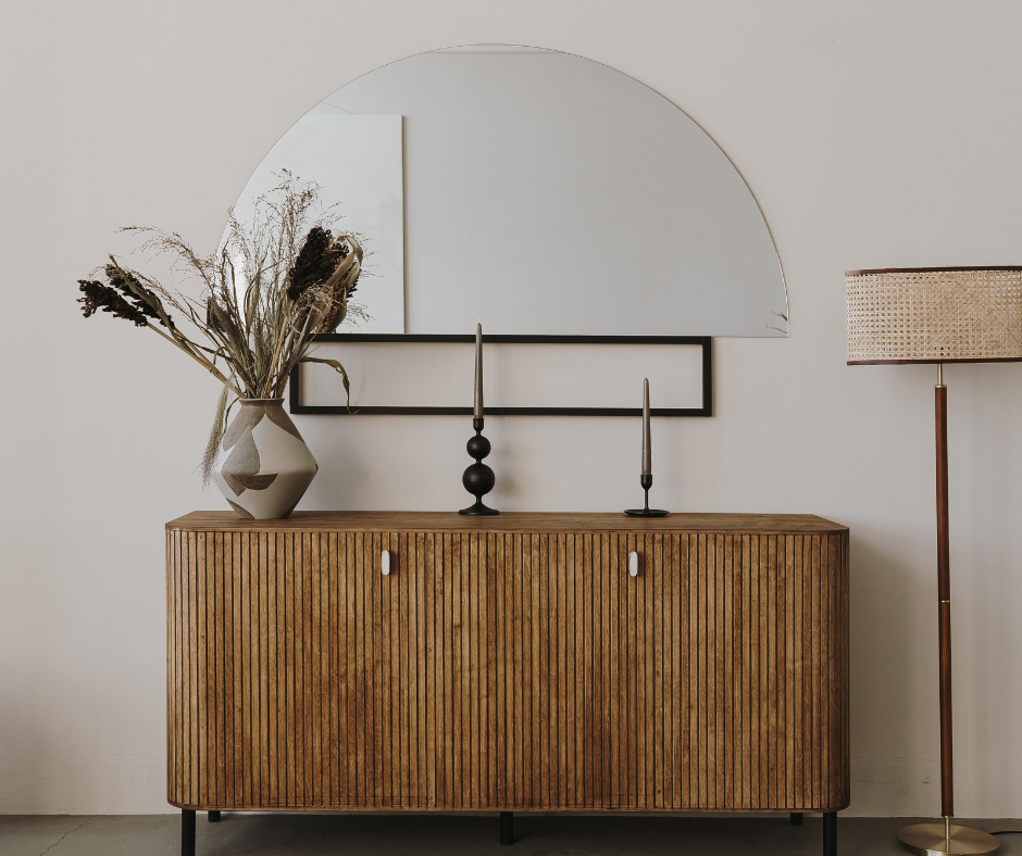 The right interior stylist can showcase products like the vase on this sideboard in front of a mirror in people's homes