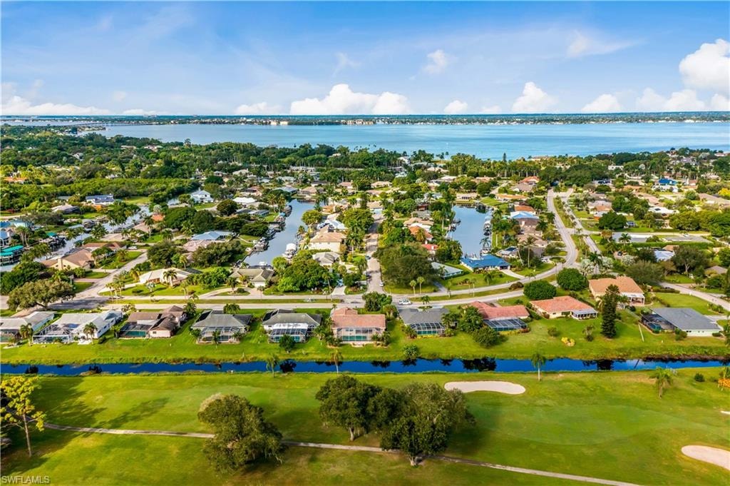 An aerial view of the Whiskey Creek community in Fort Myers, Florida, showcasing a beautifully landscaped golf course, well-maintained homes, and inviting common areas that reflect the charm of Florida living. The image captures the serene environment of this loved community, ideally situated in south Fort Myers, highlighting the perfect blend of nature and residential comfort.