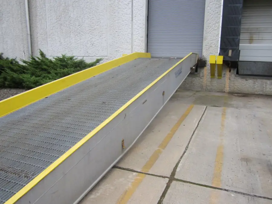 A loading dock ramp with a dock board and a ramp slope