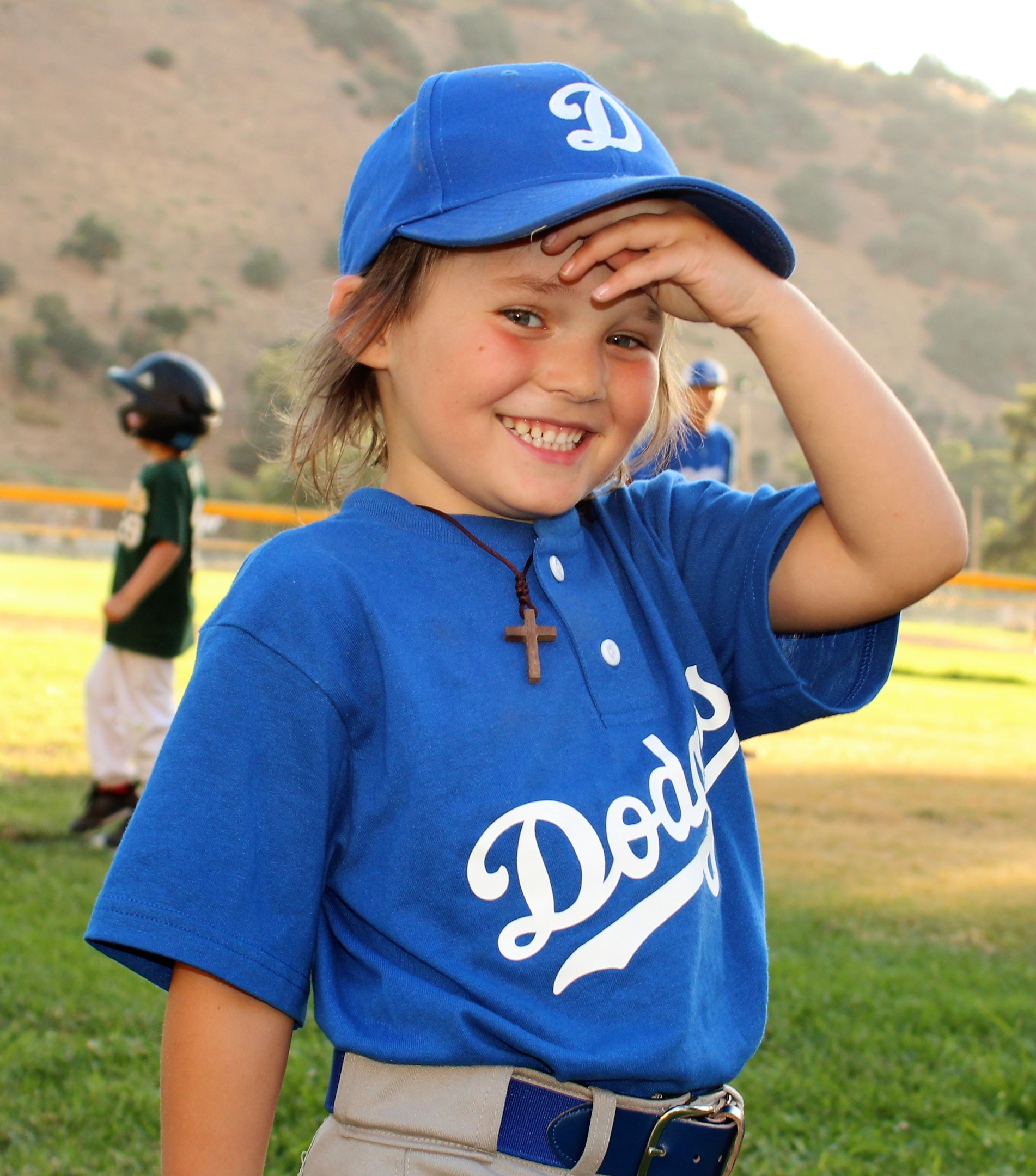 A coach showing a few balls to a group of tee ball players