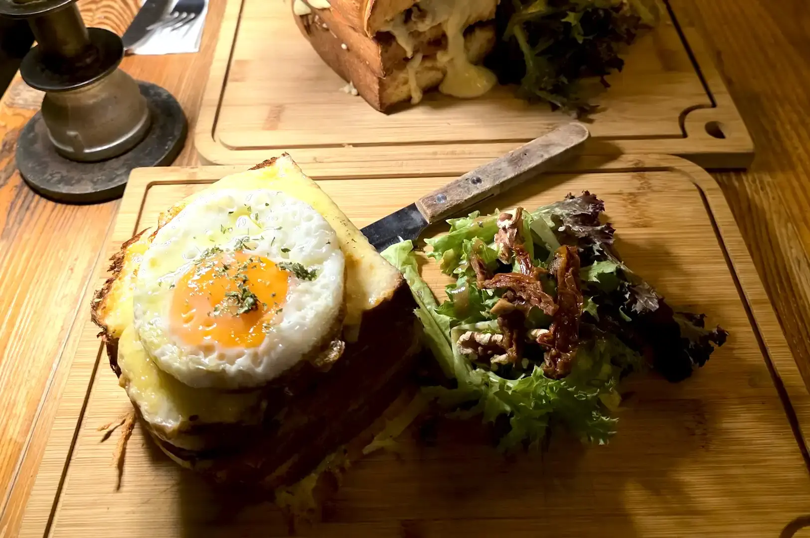 My Awesome Cafe rustic vintage interior featuring exposed brick, warm lighting, and gourmet sandwiches served on wooden boards in Singapore.