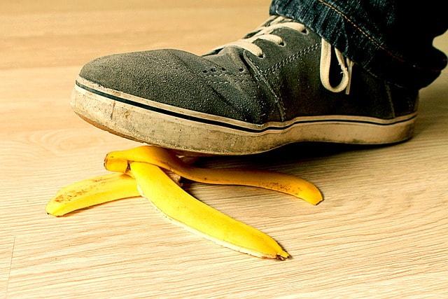 banana peel, used sneakers, wood floor