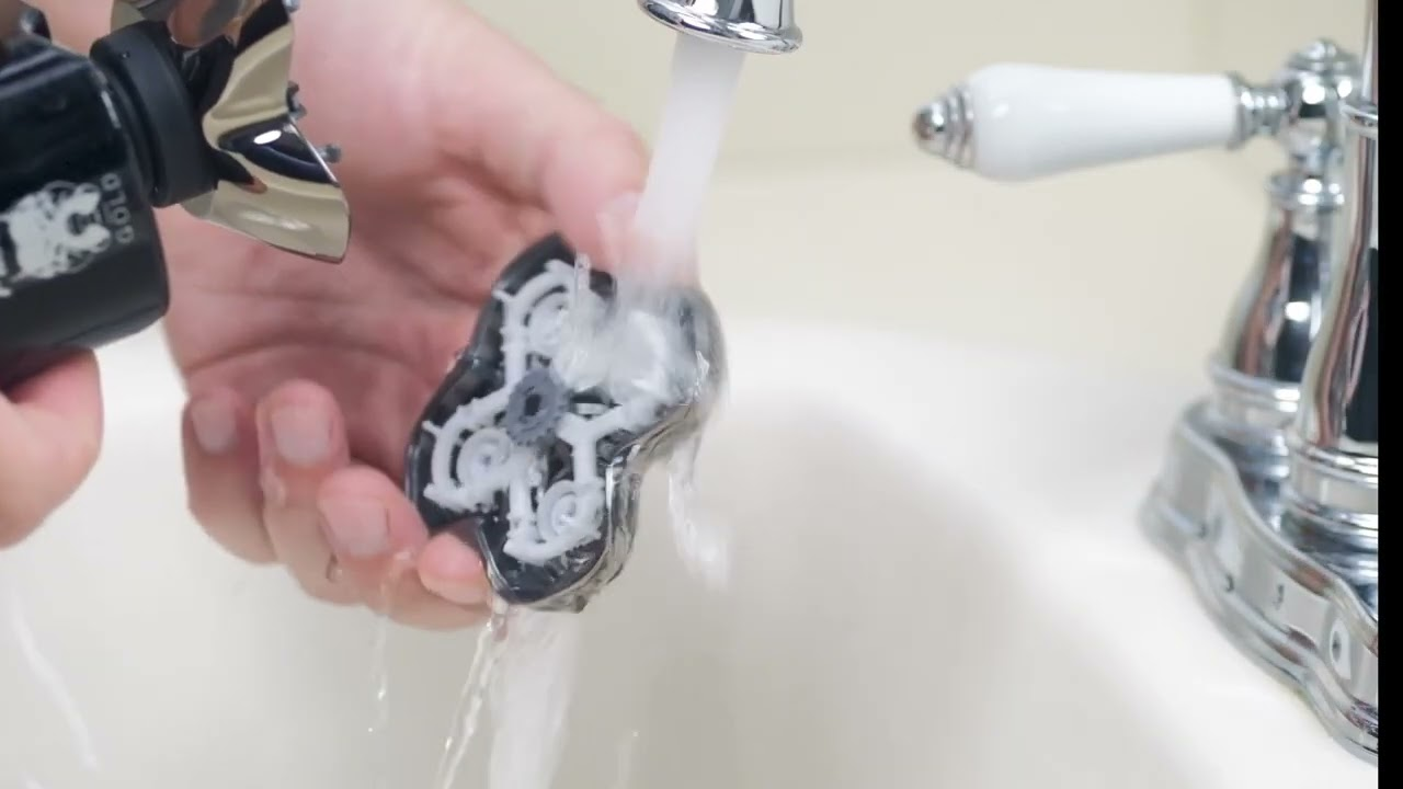A person using a spray cleaner and remain the blades sharp of the braun shaver and used water to have the electric shaver clean