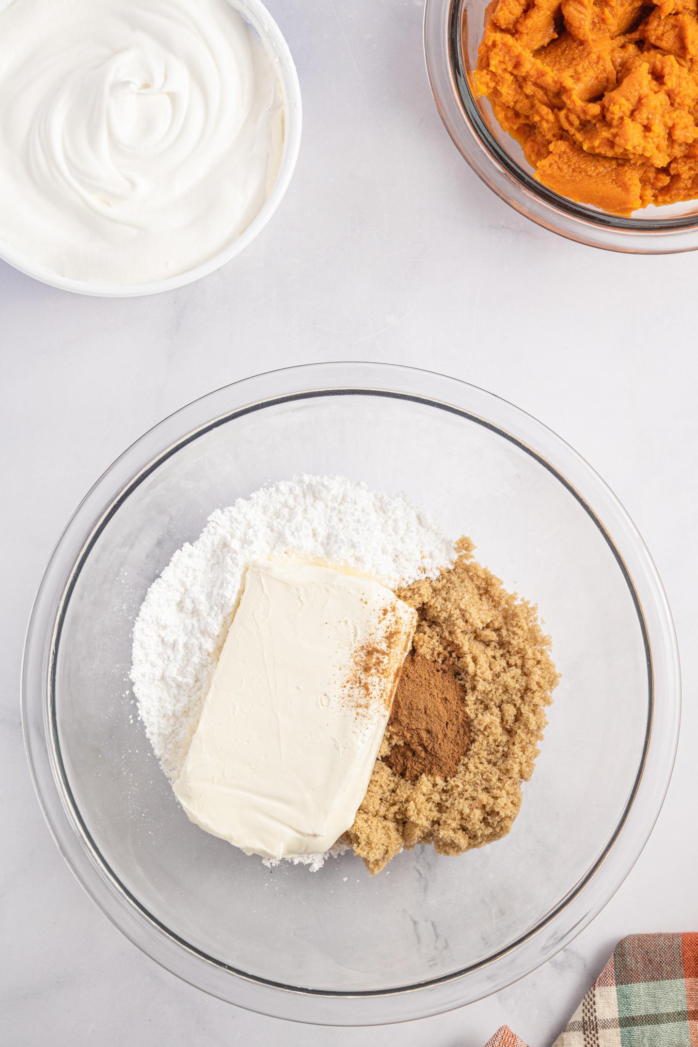 cream cheese, powdered sugar, pumpkin spice and brown sugar in a bowl