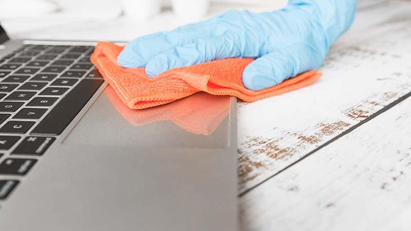 Cleaning a macbook laptop with a microfiber cloth