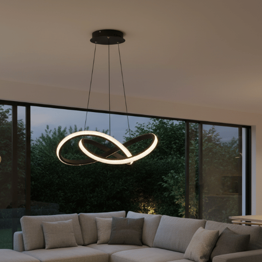 Three industrial metal pendant lights illuminating a rustic bar counter.