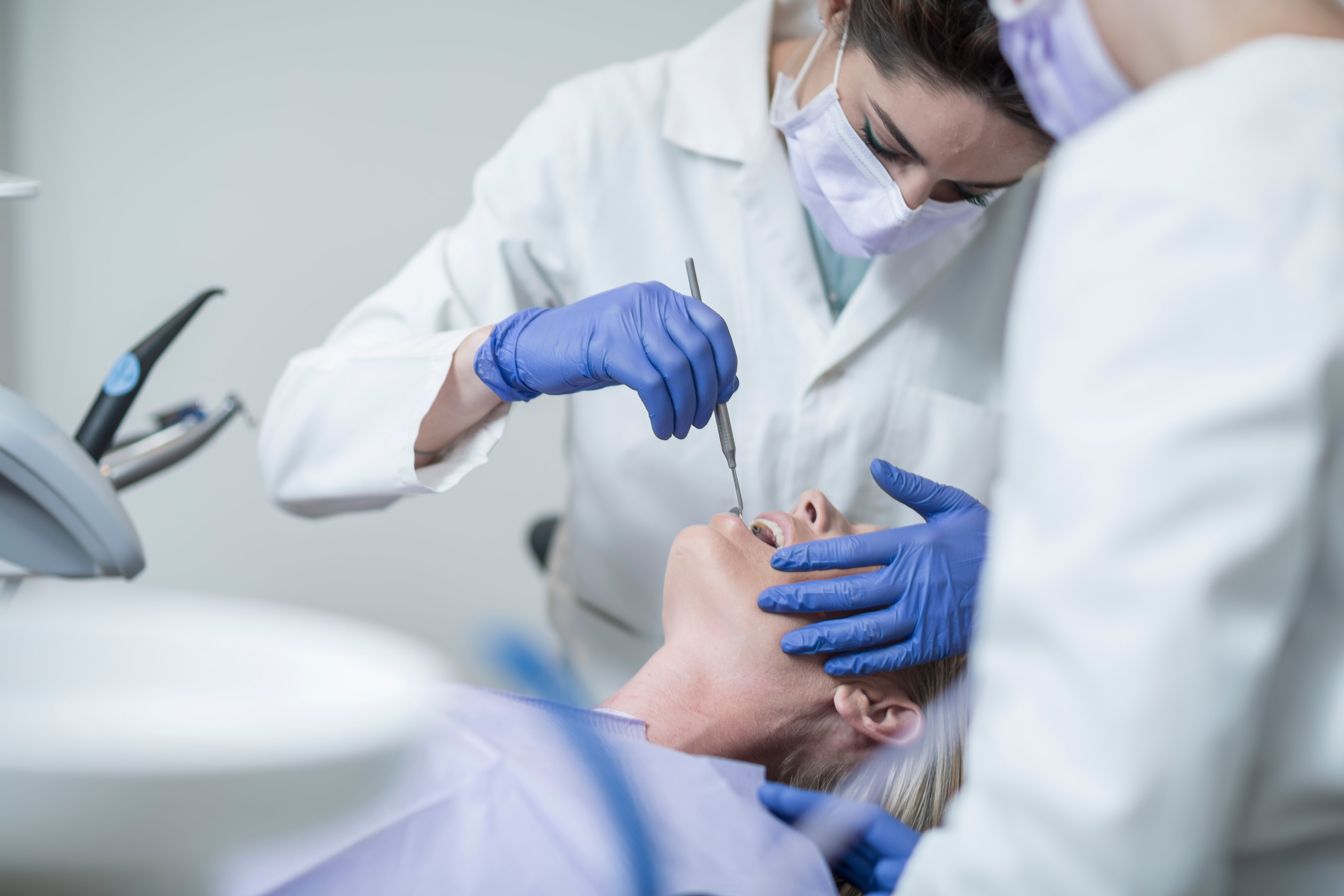 A photo of a woman check her gums that needs to be treated.