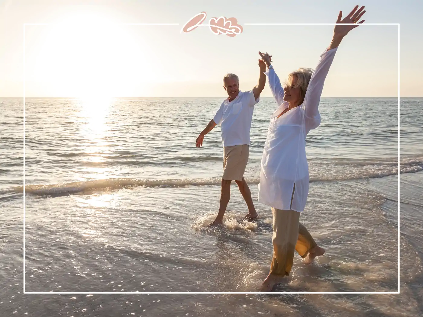 A joyful elderly couple holding hands and dancing in the surf at the beach during sunset. Fabulous Flowers and Gifts.