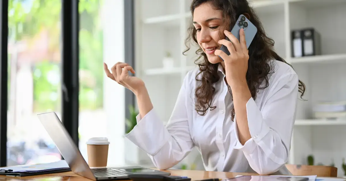 Woman learning how to talk to someone at the IRS while reviewing a tax notice and tax return.