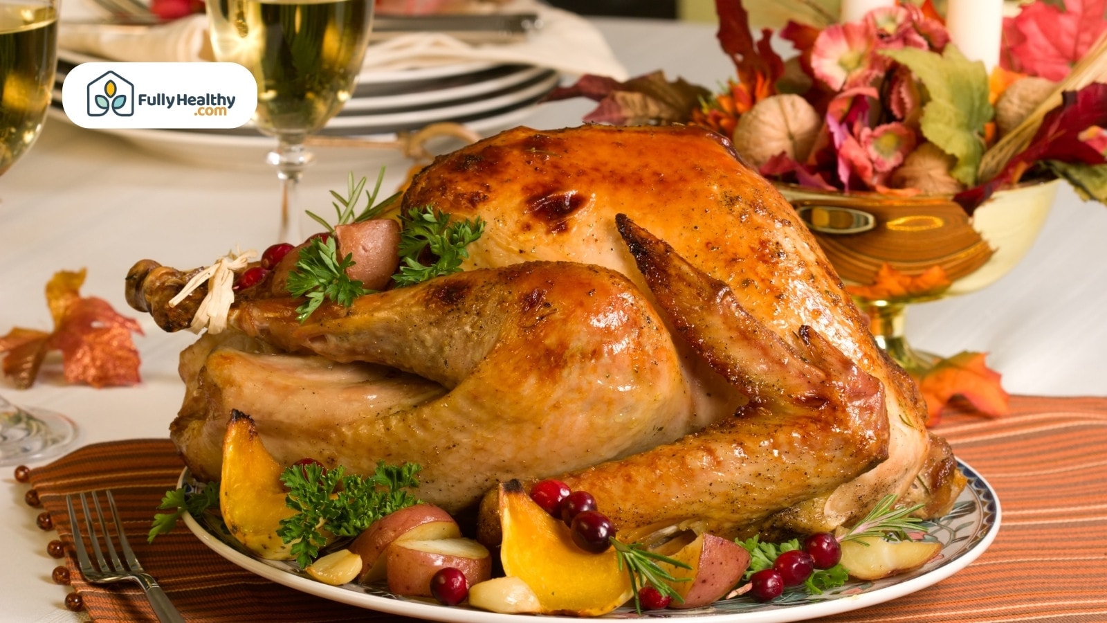 Golden roasted turkey served with potatoes cranberries and herbs on platter