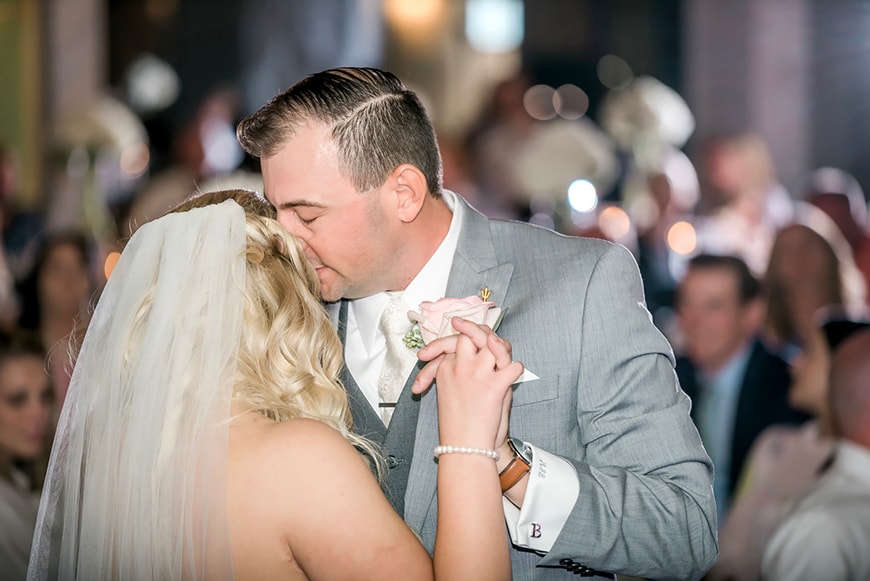 Professional photography at a wedding reception of bride and groom dancing.