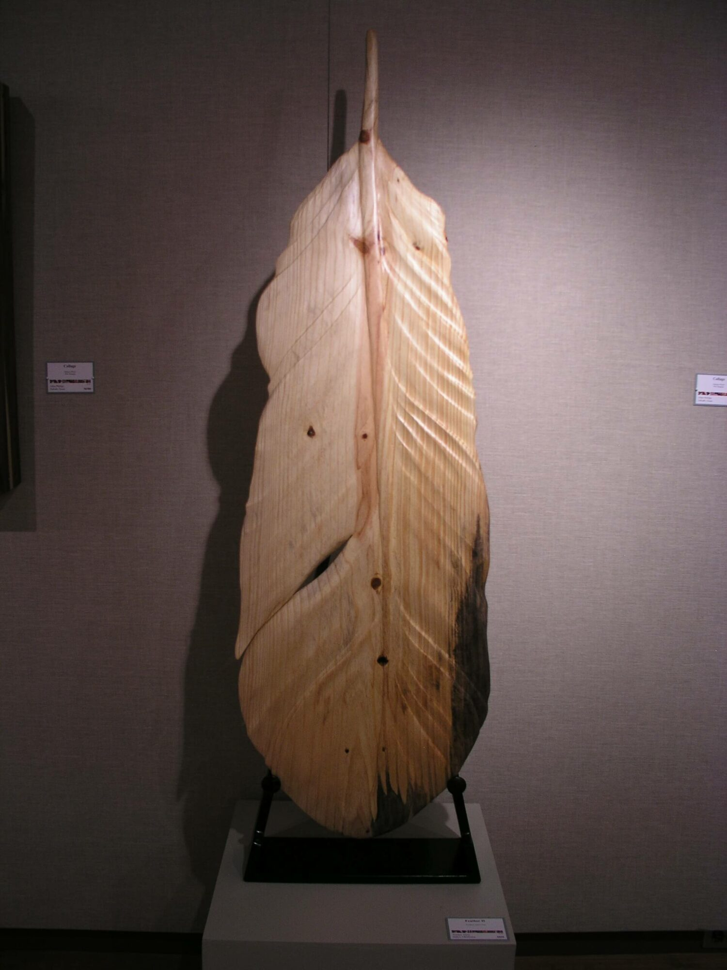 This intricate feather wood carving on display.  