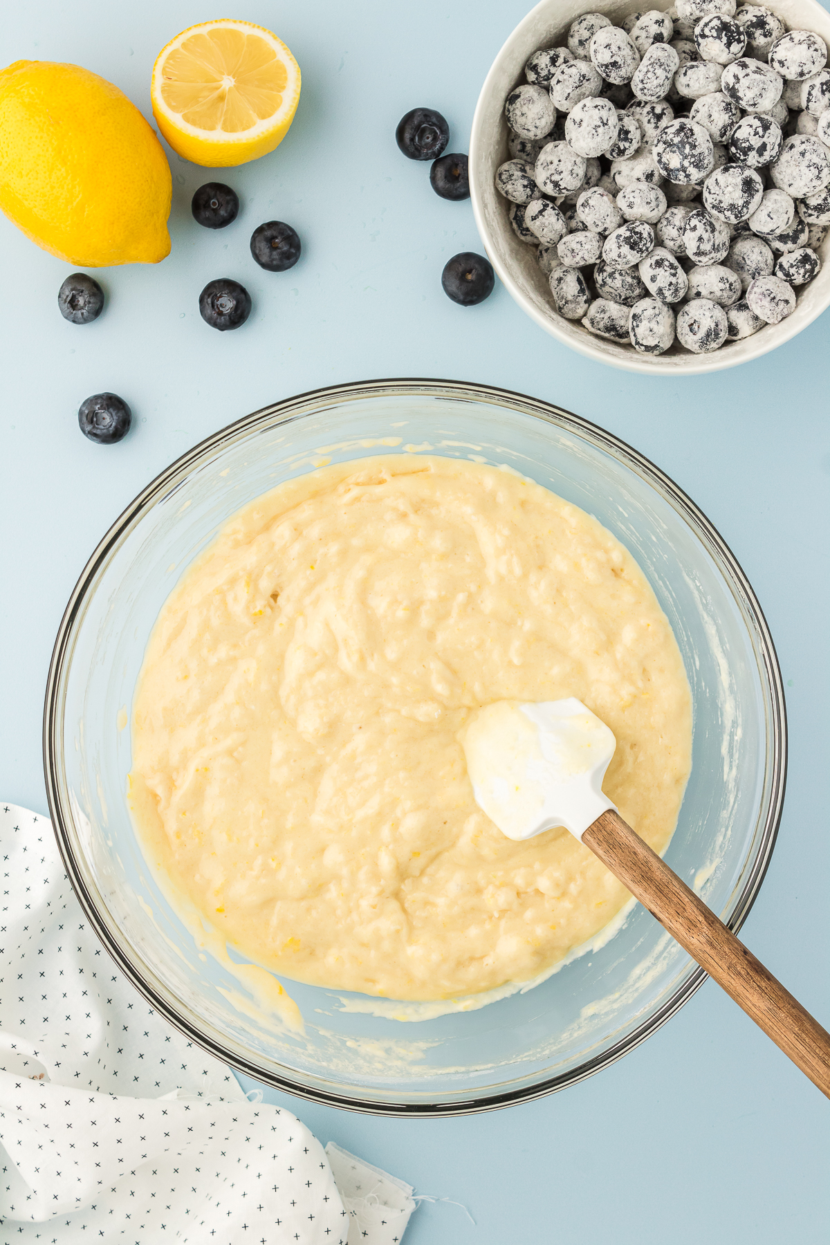 lemon blueberry quick bread batter in bowl with bowl of blueberries