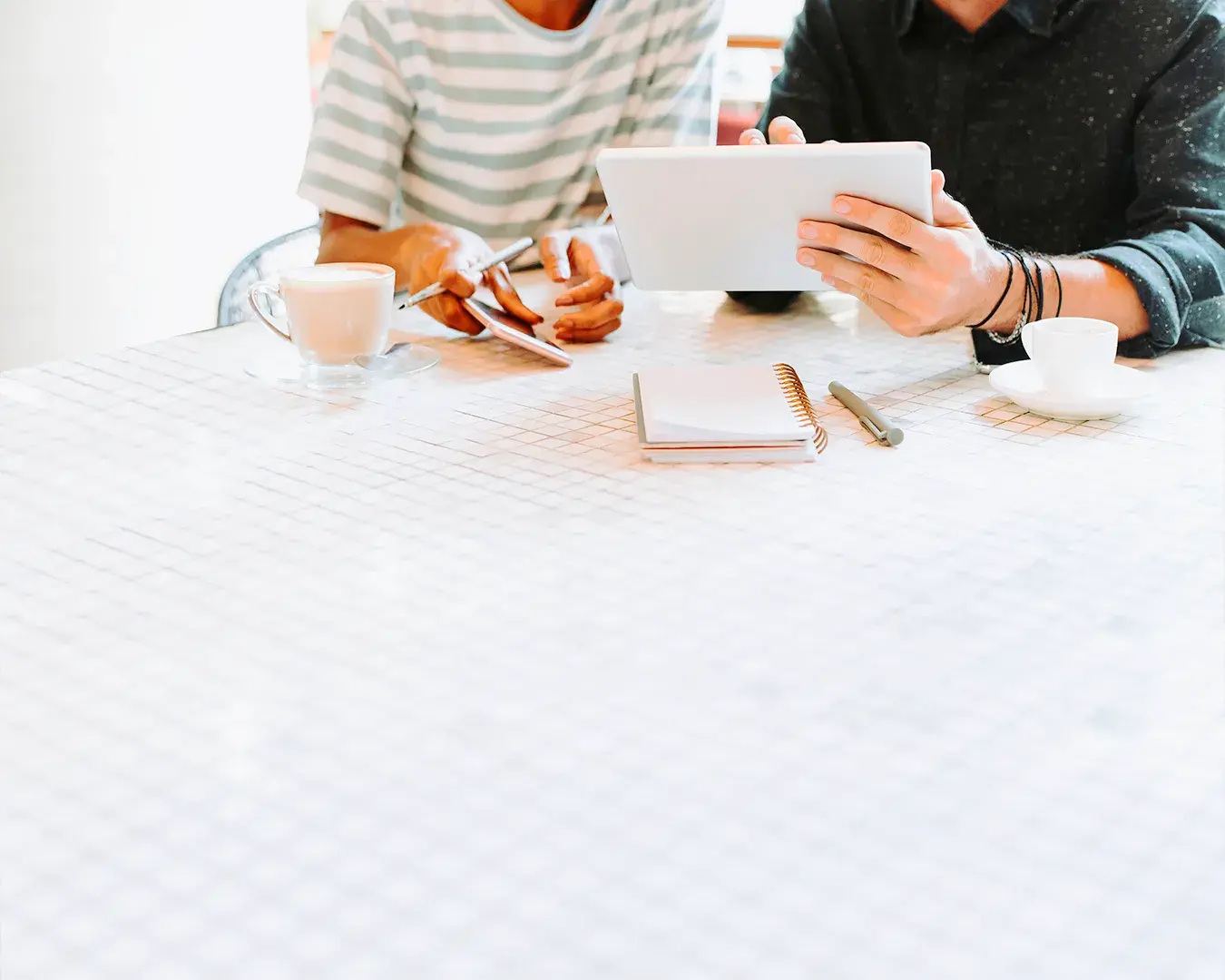 Restaurant owners reviewing tablet ordering system and digital strategy for mobile app and web app development in Singapore hospitality industry