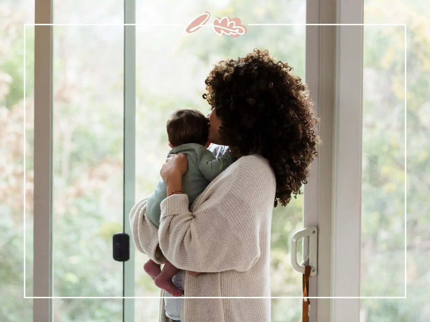 A mother holding her baby near a large window, embracing the peaceful moment. Fabulous Flowers and Gifts.