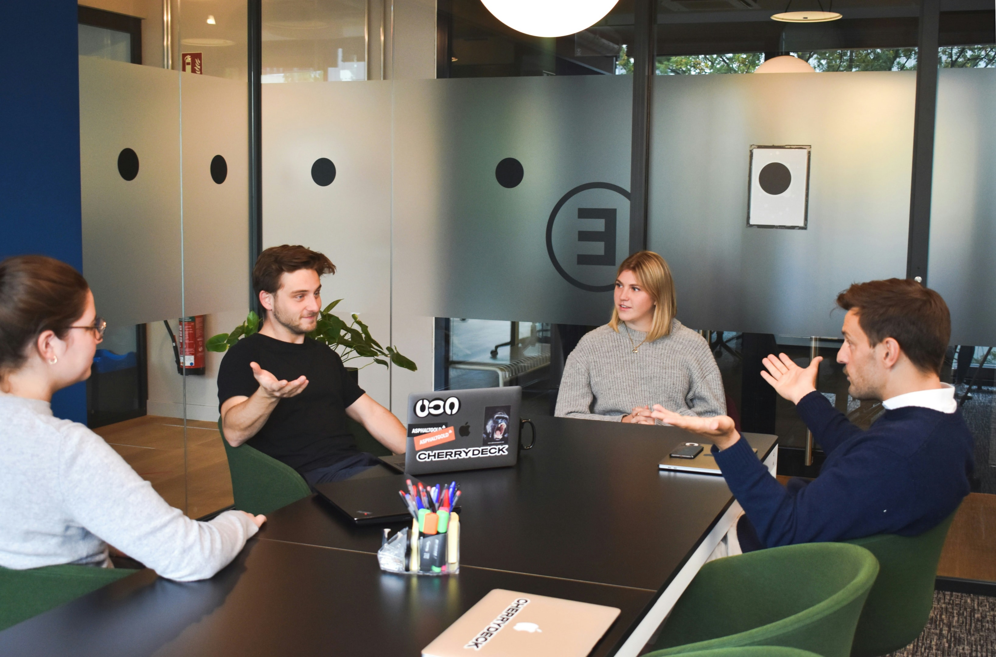 Team of real estate investors meets to discuss their mail campaign.
