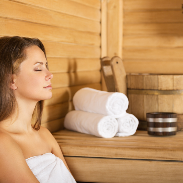 A woman enjoying the inside of an outdoor sauna
