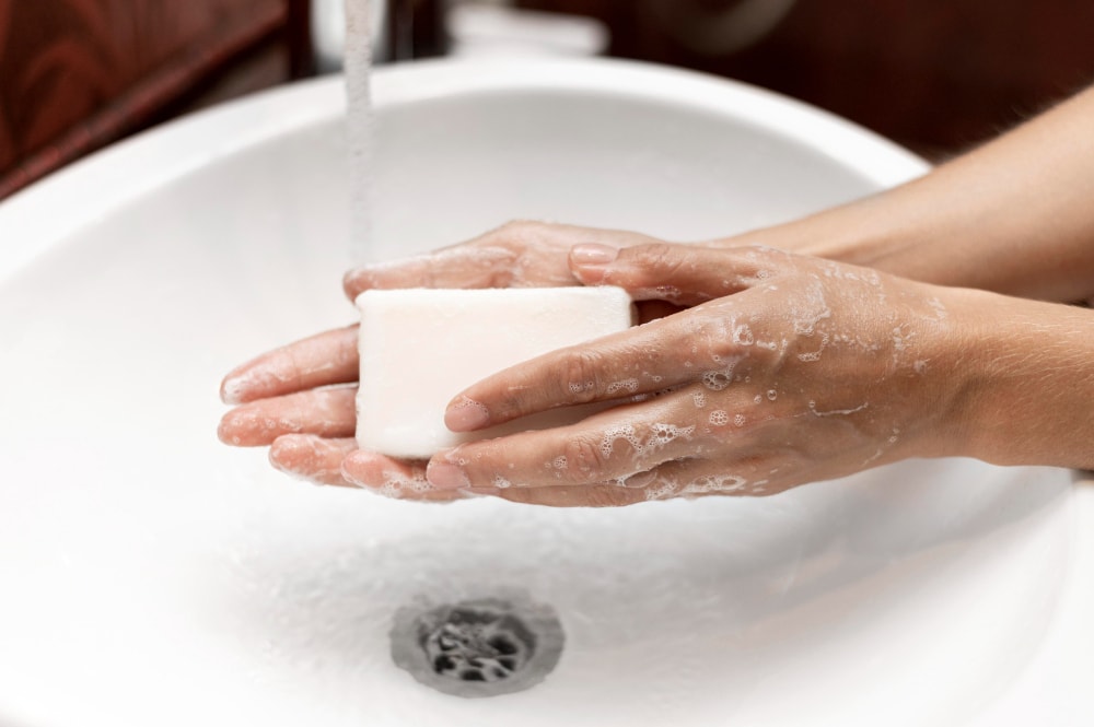 Washing your hands running water and antibacterial soap
