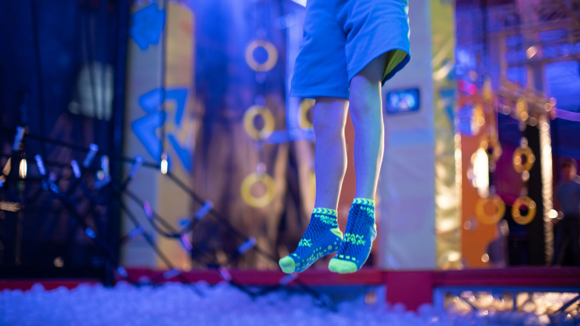 A child's feet wearing Urban Air socks as they jump at Urban Air Adventure Park Birthday Party