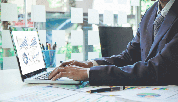 Business Man on Computer Reviewing Data.