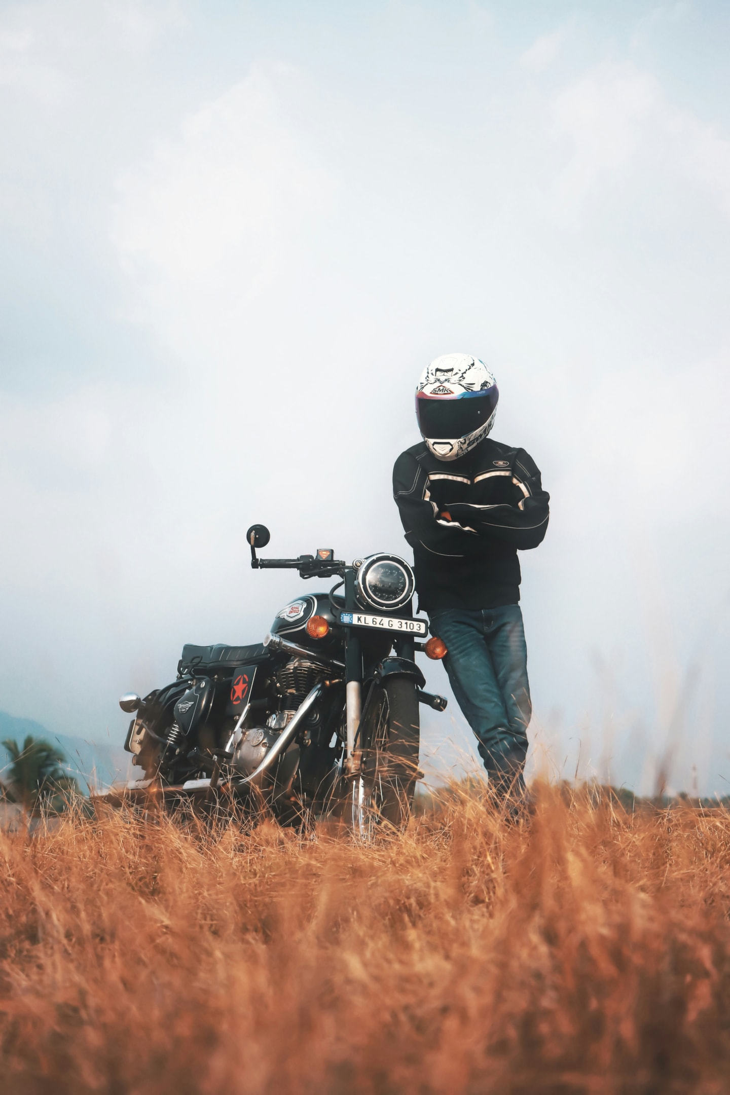 biker in a field with motorcycle