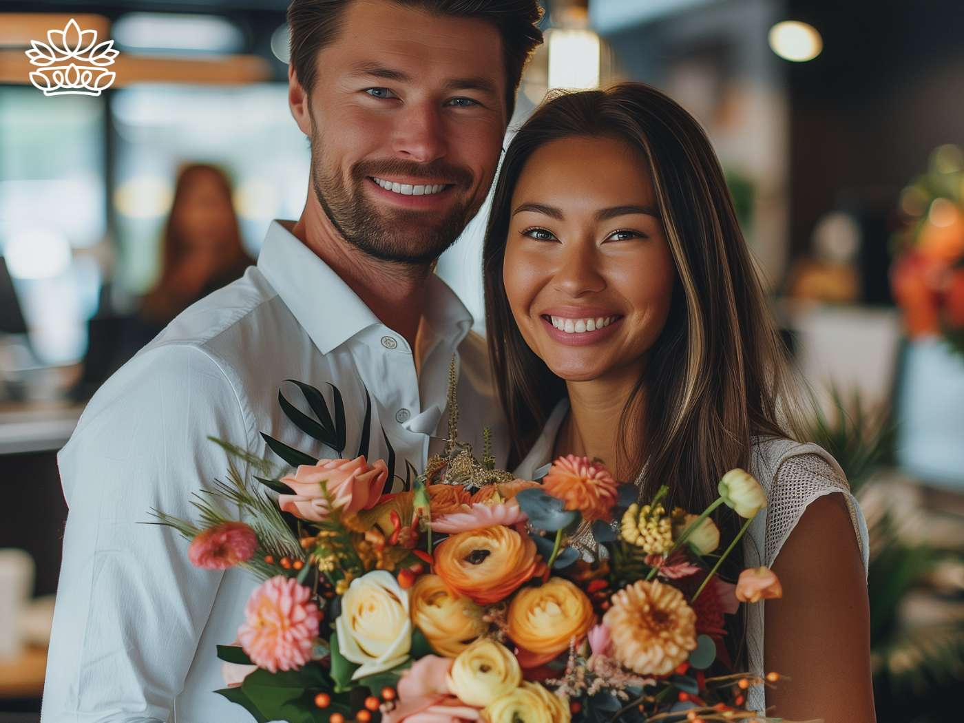 A cheerful colleagues embracing, with the woman holding a stunning bouquet of orange and peach roses, symbolizing the joyous moments celebrated at Fabulous Flowers and Gifts.