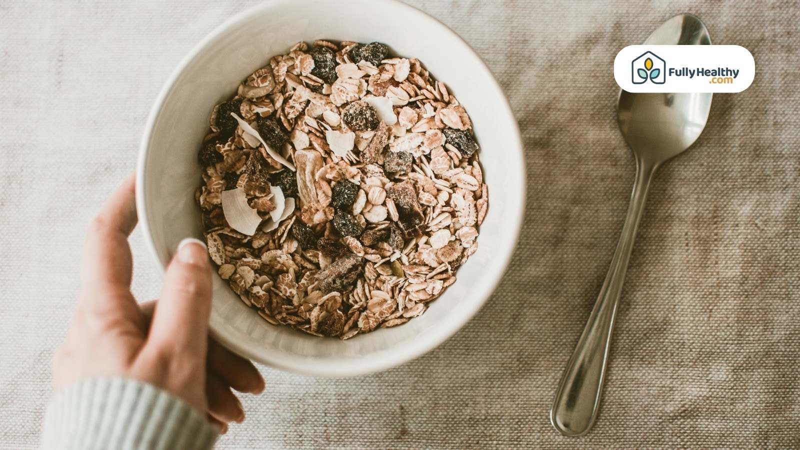 Cornflakes with milk and fresh strawberry slice on silver spoon