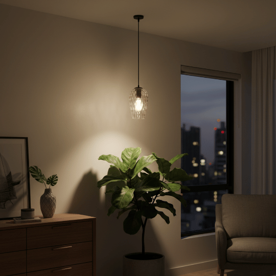 Clear glass pendant light hanging in a modern bedroom corner highlighting a plant.