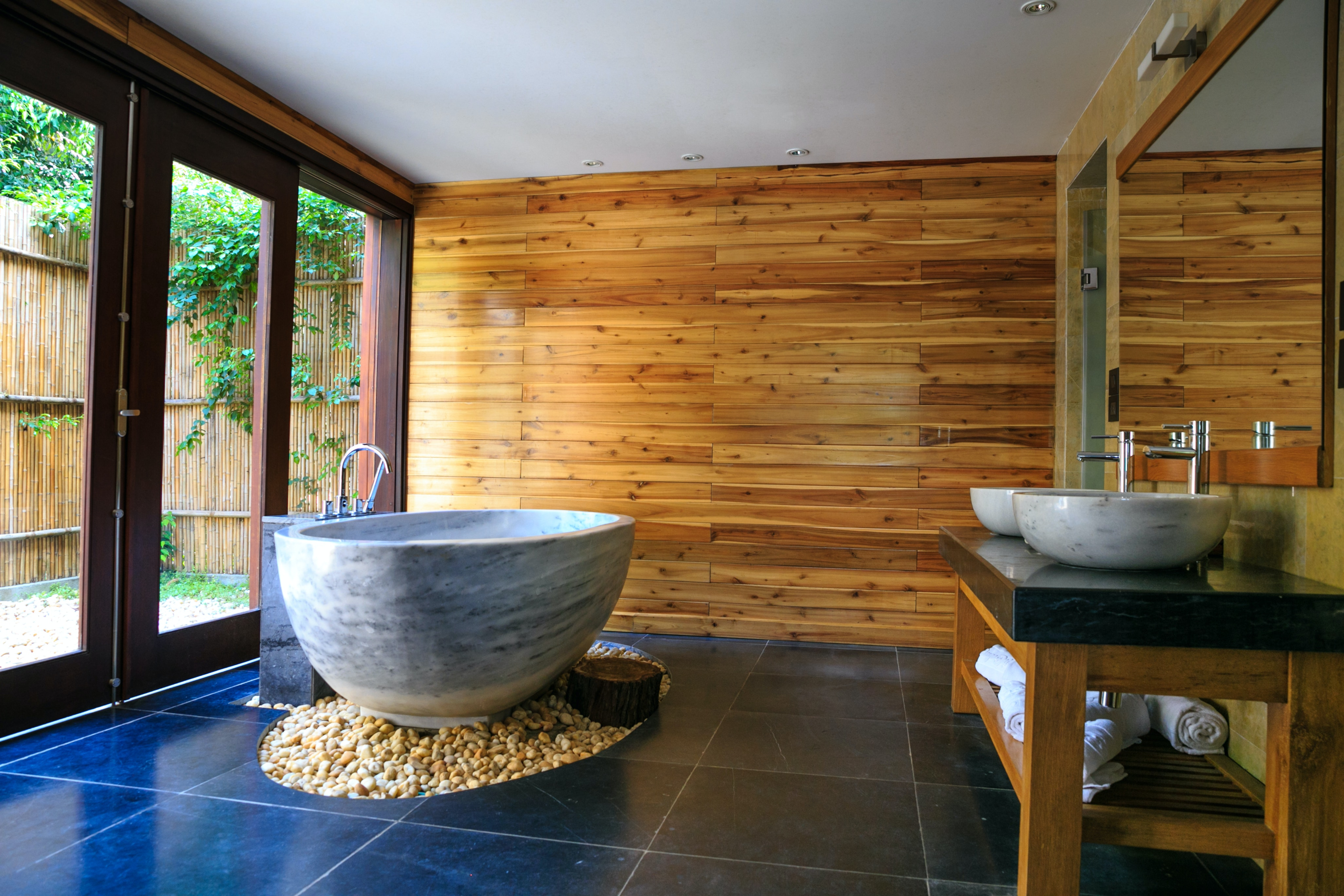 reclaimed wood accent wall with modern ceramic tub