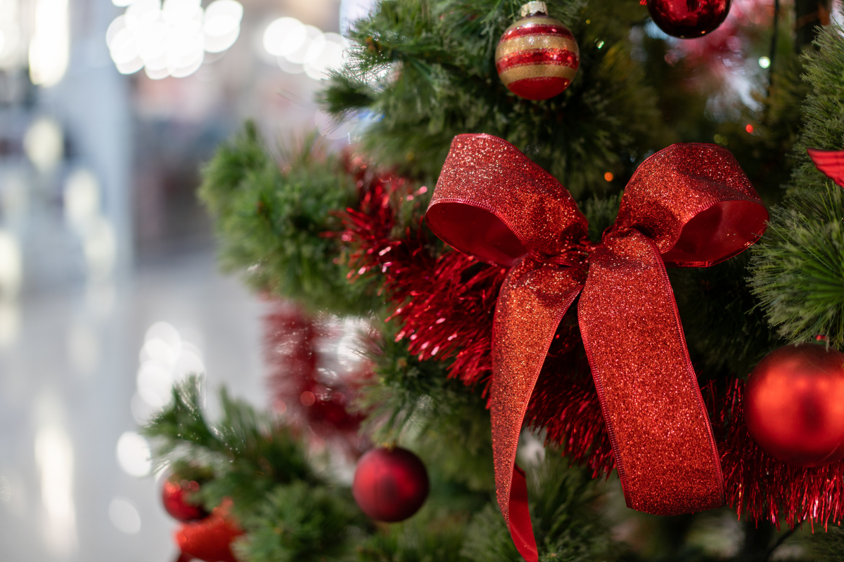 A vibrant ribbon garland draped on a Christmas tree.