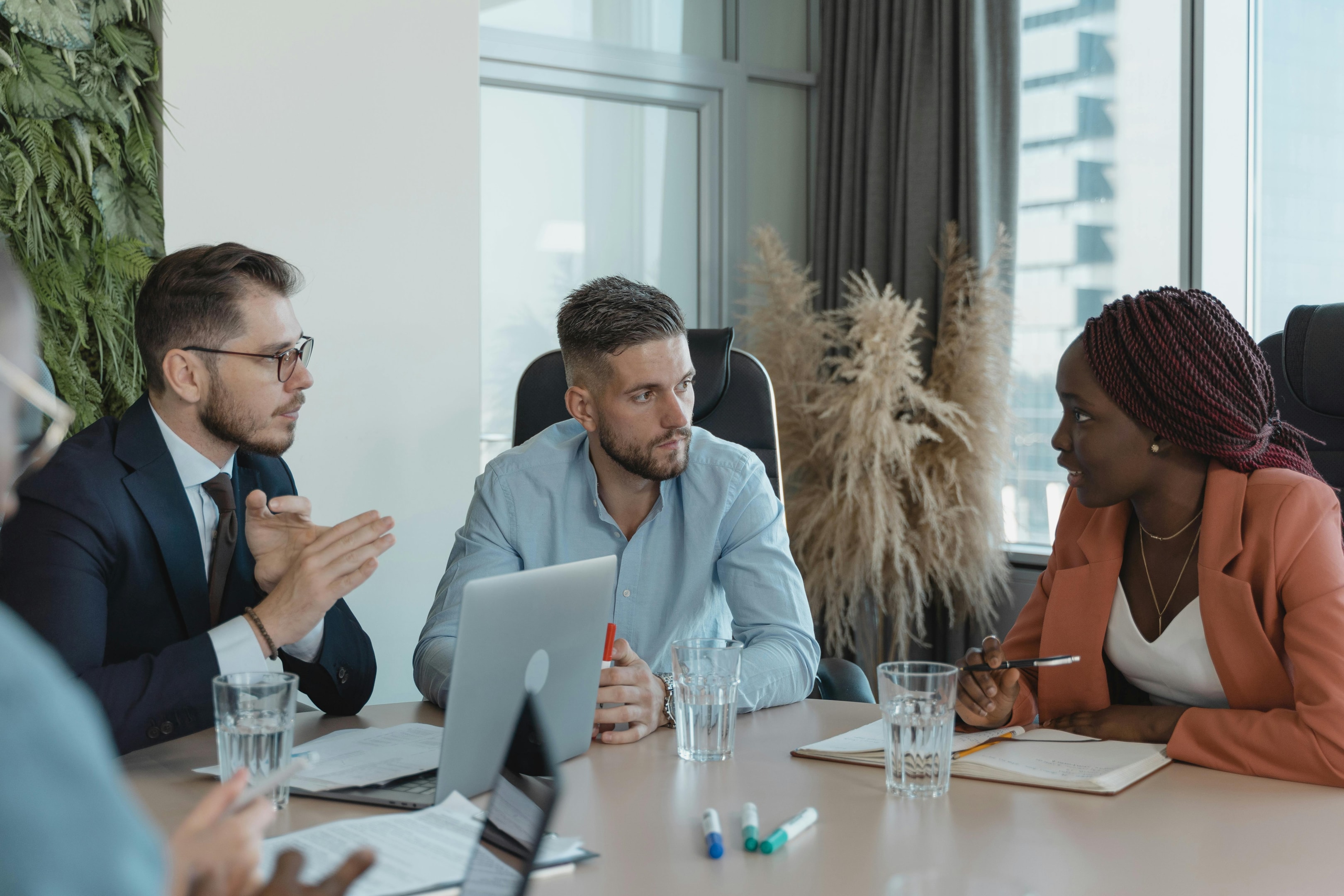 Team of real estate investors and agents meet to discuss different investment strategies.