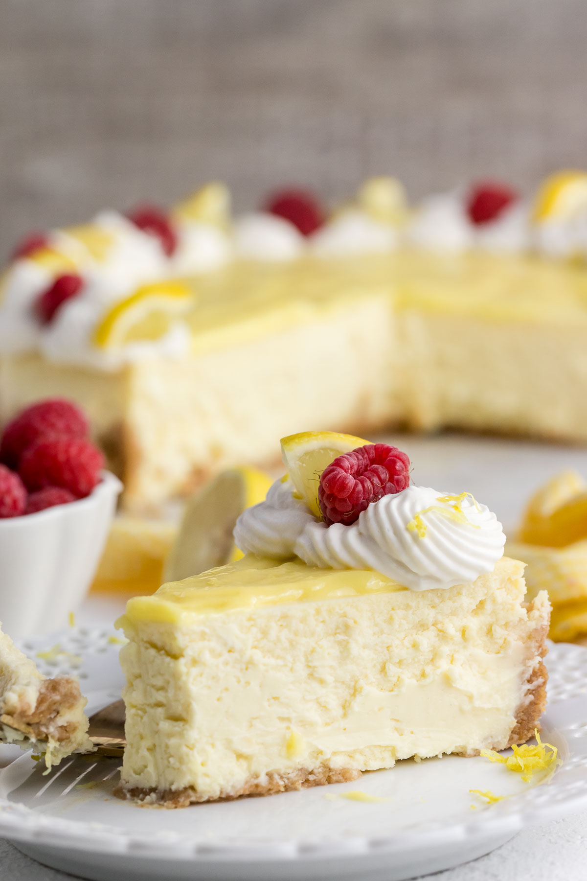 slice of lemon cheesecake on a plate with a fork
