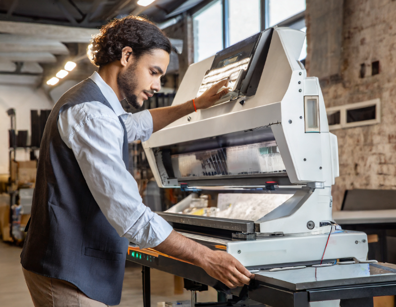 Guy working with screen printing machine - screen print - popular technique - multiple copies - multiple items