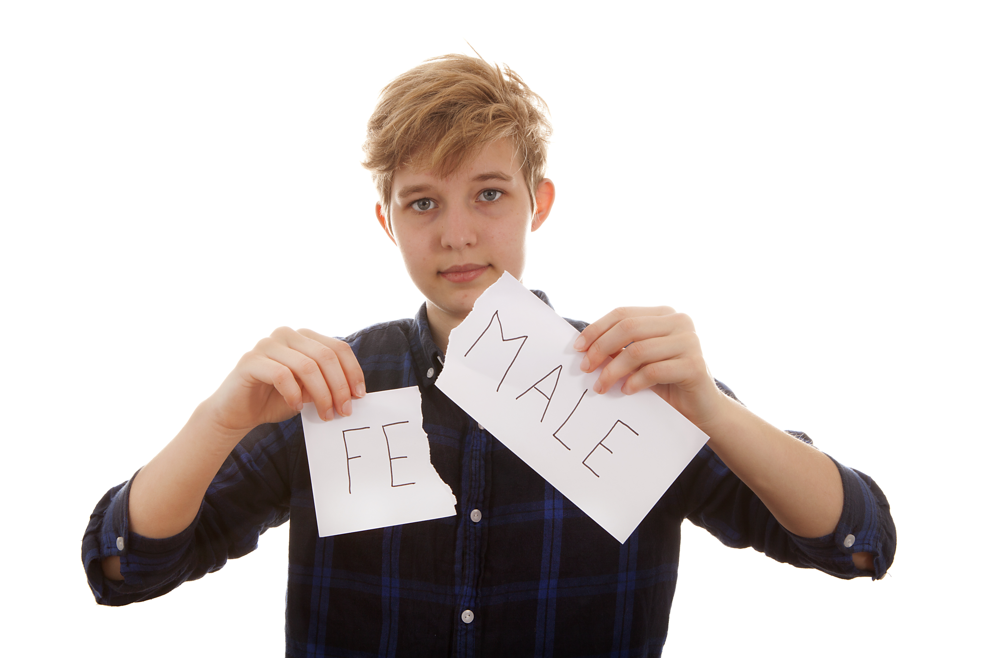 Image of a caucasian transgender individual with short sandy hair and a black shirt, holding a ripped sign that says "Fe" on one side and "Male" on the other.