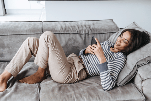 woman relaxing on couch while undergoing recovery for orthognathic surgery