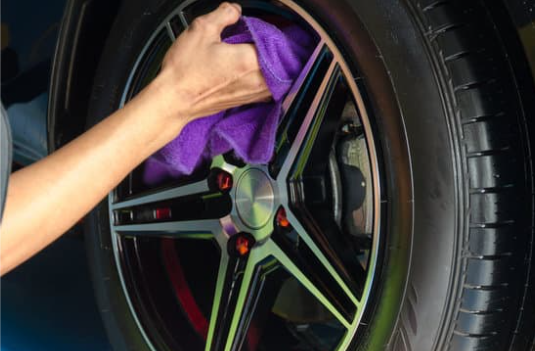 Man polishing aluminum wheels