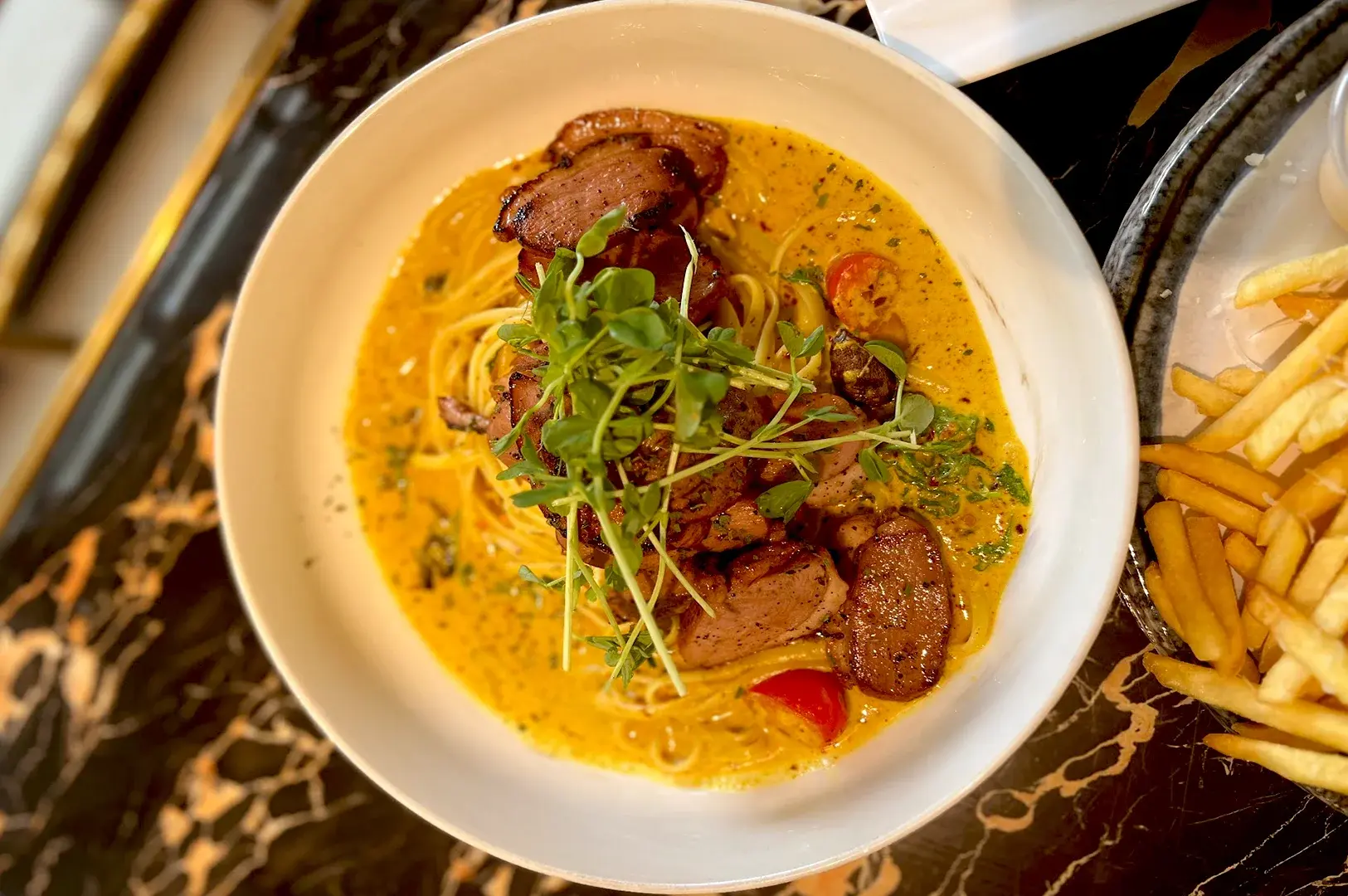 Signature Smoked Duck Chili Padi Pasta at The Malayan Council, a flavorful fusion dish featuring tender smoked duck in a creamy, spicy chili padi sauce, showcasing authentic halal-fusion cuisine in Singapore.