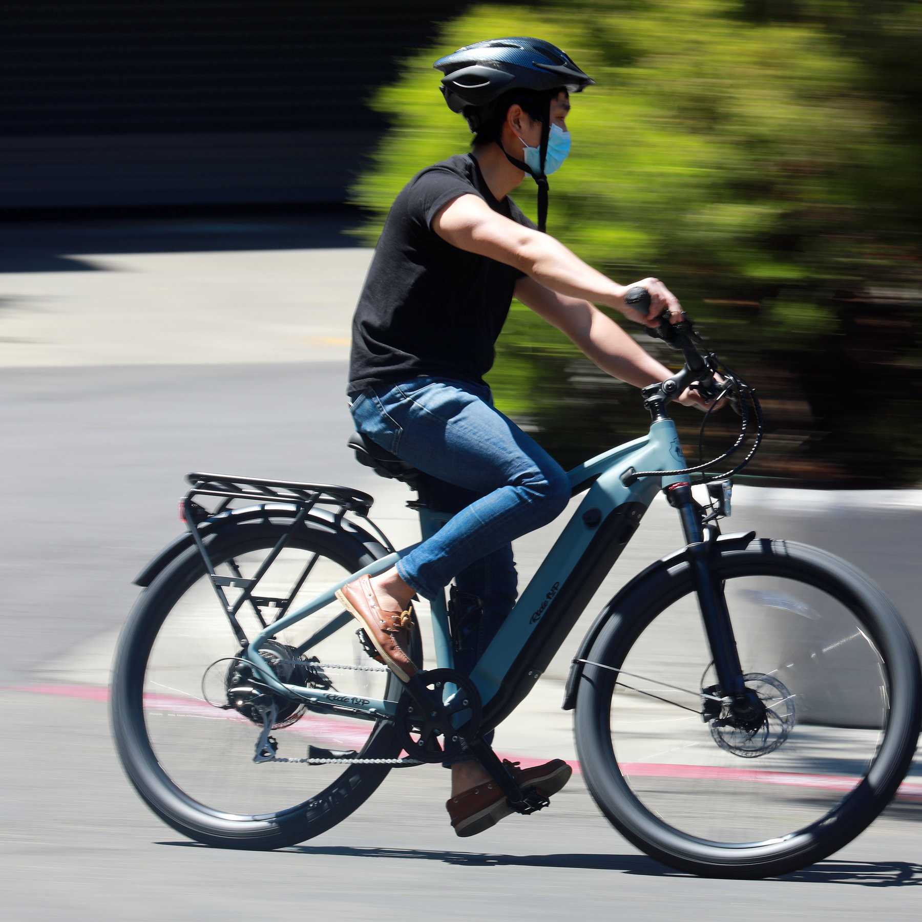 A person using an electric bike from a bike shop following the e bikes guide